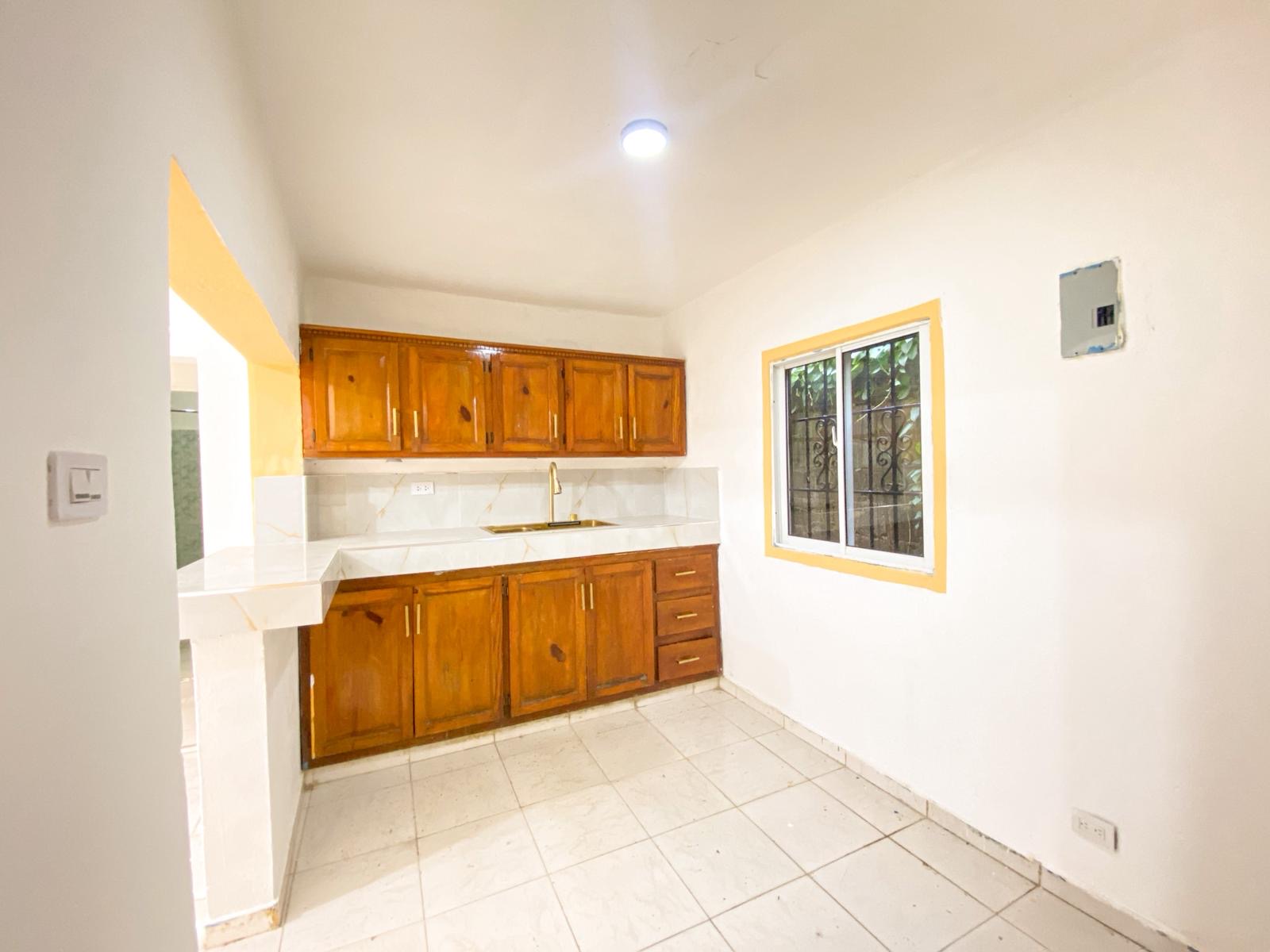 Long-term apartment — warm wood kitchen with gold fixtures